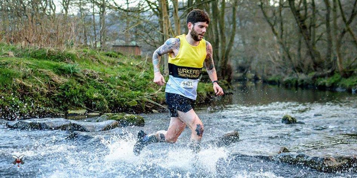 man running through a stream