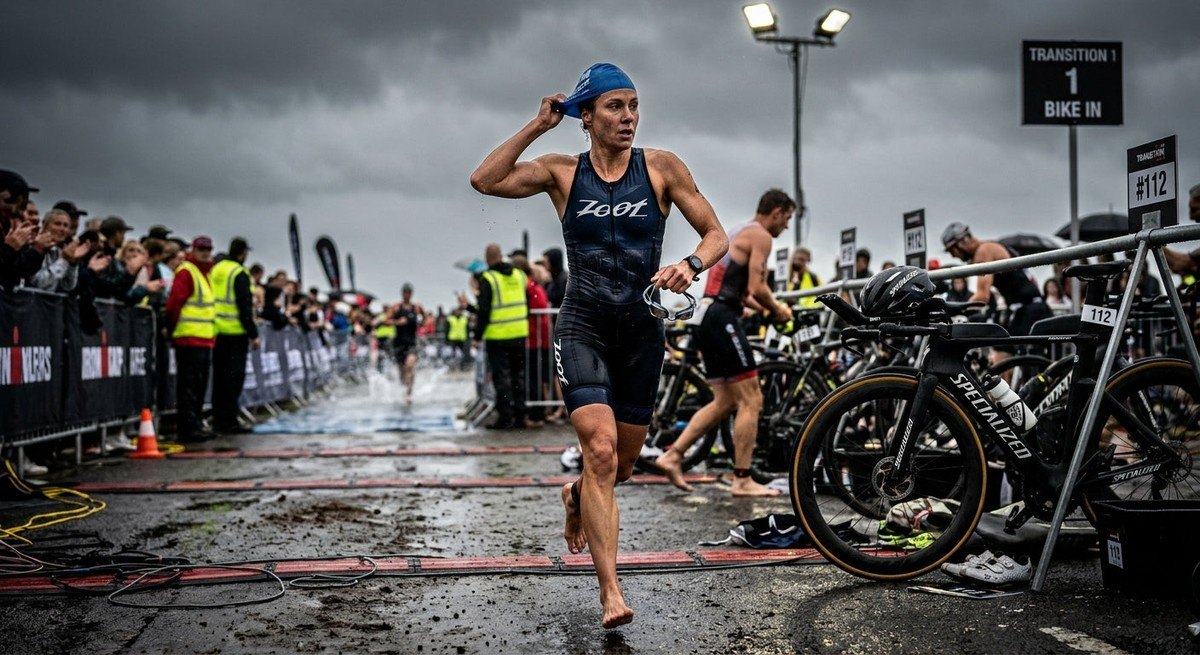 Moody, cinematic shot of a runner transitioning from a swimming segment to a cycling transition, showcasing sharp textures and athletic movement.