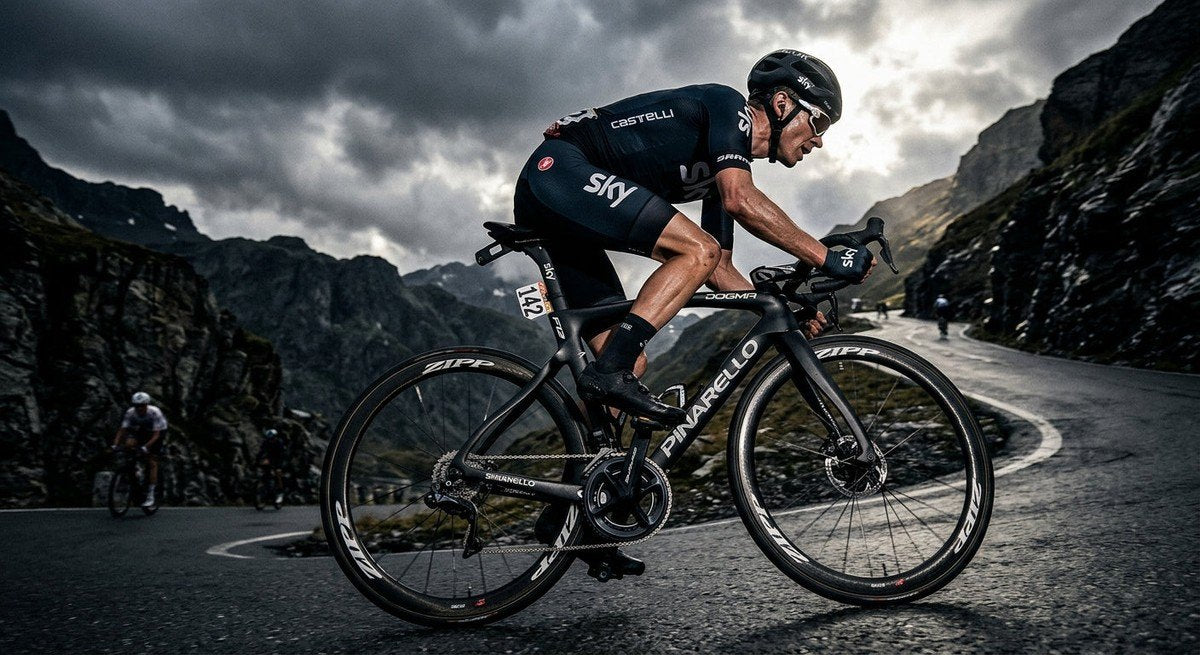 Professional cyclist racing on a mountain pass with intense focus, highlighting the aerodynamic profile of the drivetrain in a moody, high-contrast environment.