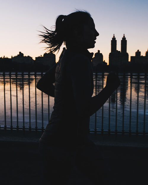 running at night silhouette woman outdoors city