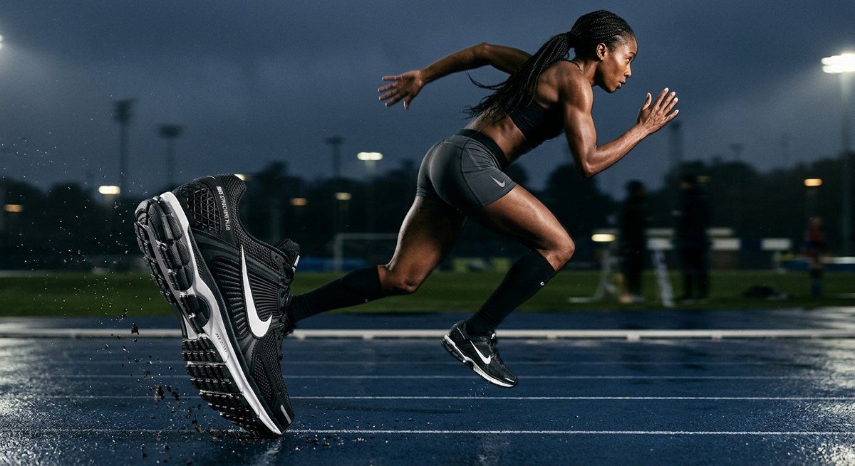 Side profile of the Nike Structure Plus captured during a sprint, highlighting the sleek silhouette and sharp design details.